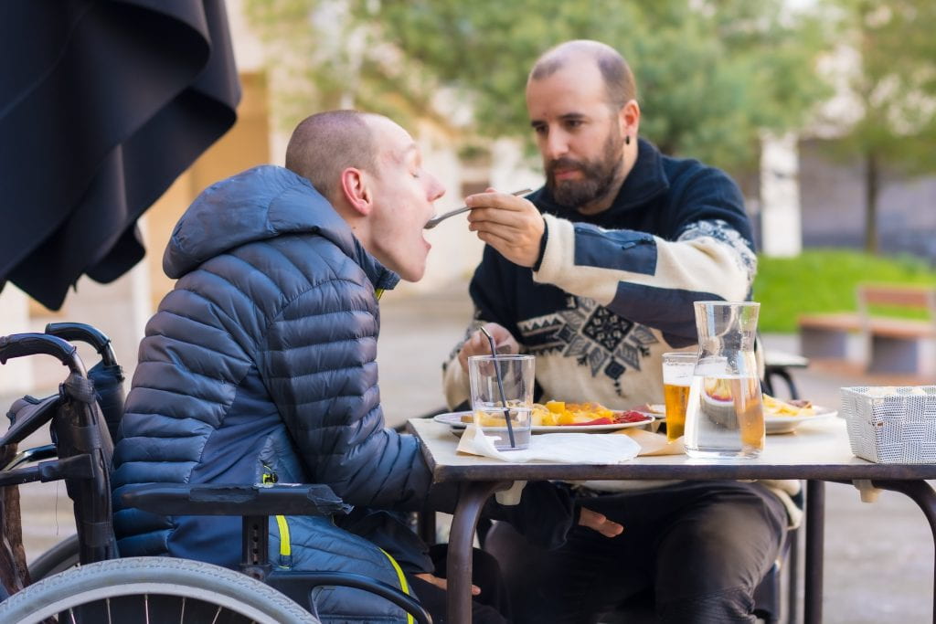 Man in wheelchair eating